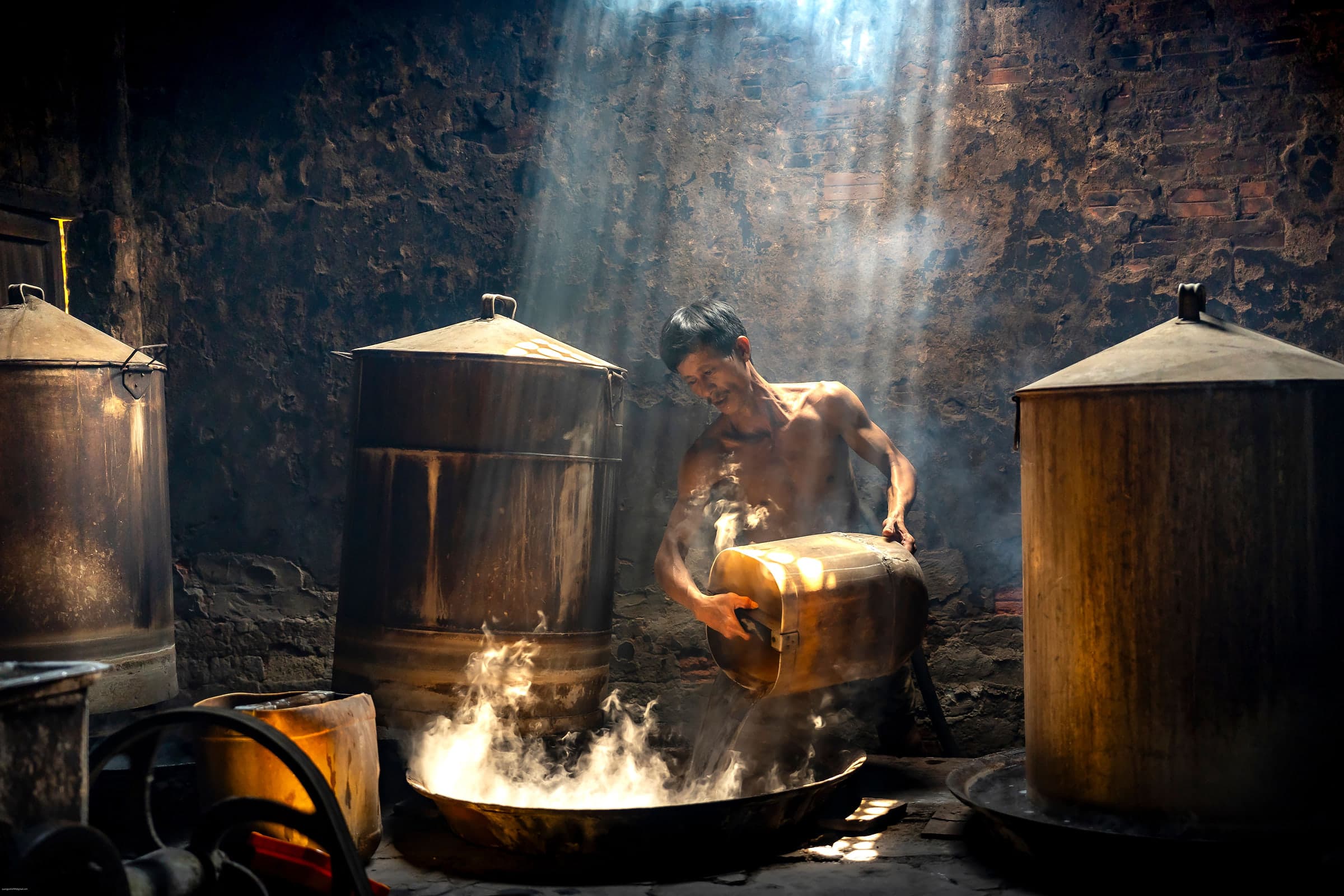 A distiller at work in a traditional Chinese distillery